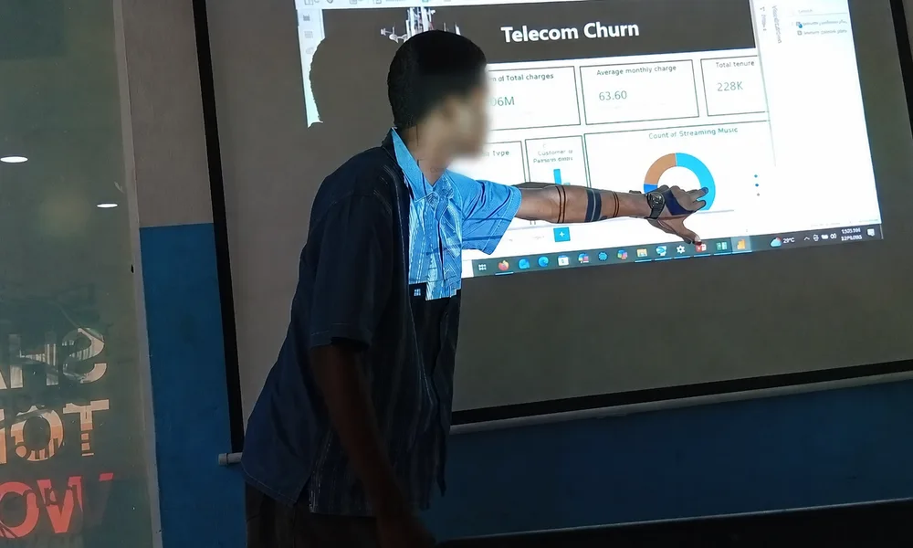 Learner presenting a telecommunications churn capstone dashboard, with face blurred for privacy